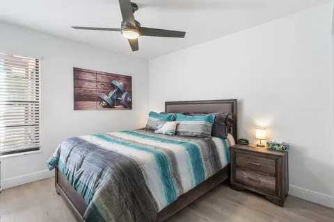 a bedroom with a bed and a chandelier