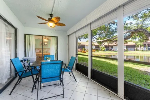 a dining room with furniture and a floor to ceiling window