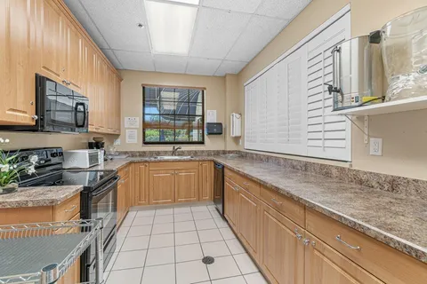 a kitchen with stainless steel appliances granite countertop a sink and a stove