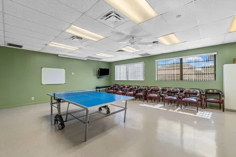 a room with furniture and pool table