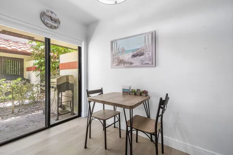 a view of a dining room with furniture and front door