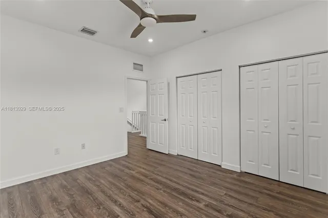 a white toilet sitting next to a shower
