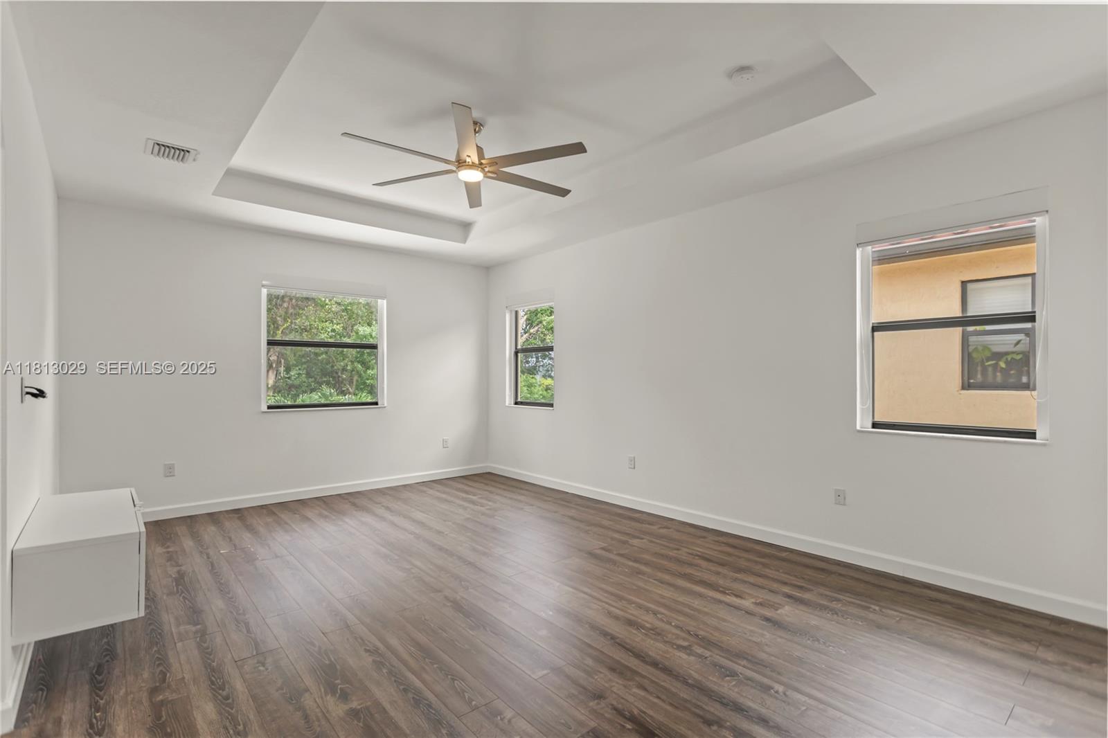 3502 West 86th Terrace Hialeah, FL 33018 - Photo 42 of 68 a view of an empty room with a window and wooden floor