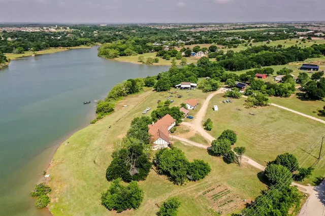 an aerial view of a house with a lake view