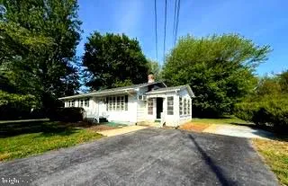 a front view of a house with yard and green space