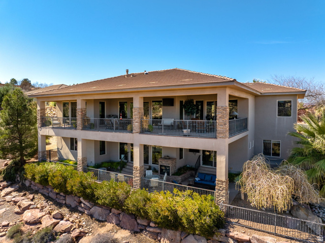 2376 Stone Crest Circle St. George, UT 84790 - Photo 54 of 61 Rear view of house featuring stucco siding, a fenced backyard, a balcony, a tiled roof, and a patio area