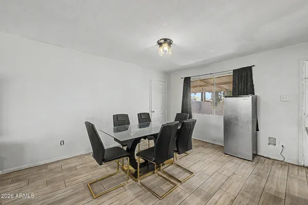 a workspace room with wooden floor furniture and windows
