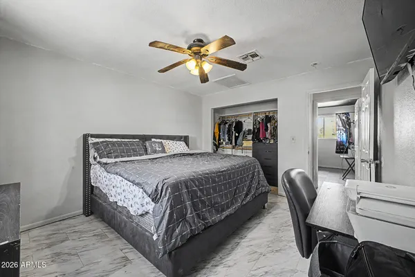 a bedroom with a bed and a chandelier