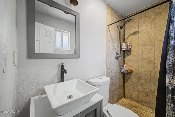a bathroom with a sink toilet and shower