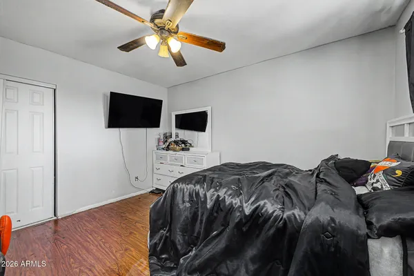 a bedroom with a bed and a flat screen tv