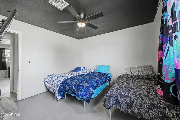 a bedroom with bed and a chandelier