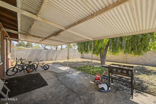 a view of a patio with table and chairs and potted plants