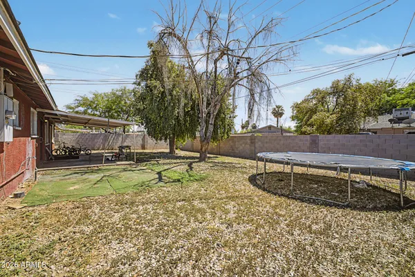 a view of a house with backyard and sitting area