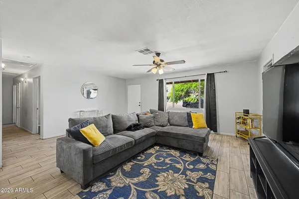 a living room with furniture and a flat screen tv