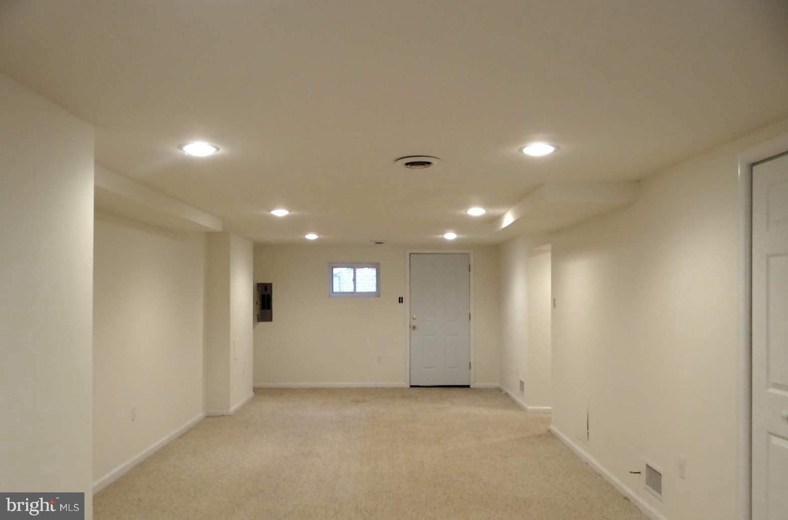 121 Whitmoor Terrace Silver Spring, MD 20901 - Photo 6 of 11 an empty room with wooden floor and windows