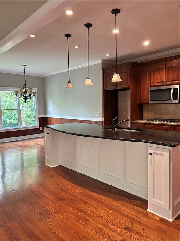 348 Hidden Trail Pendergrass, GA 30567 - Photo 14 of 40 a kitchen with kitchen island a counter top space a sink and wooden floor