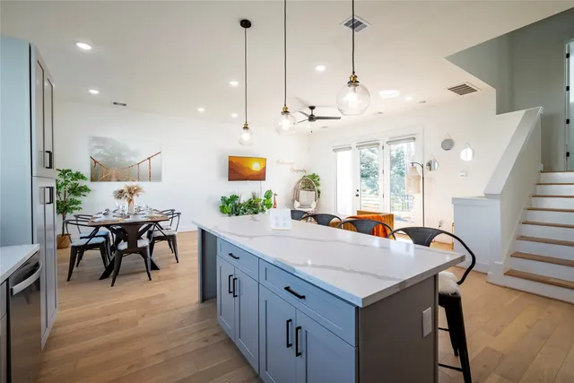 a kitchen with sink cabinets and wooden floor