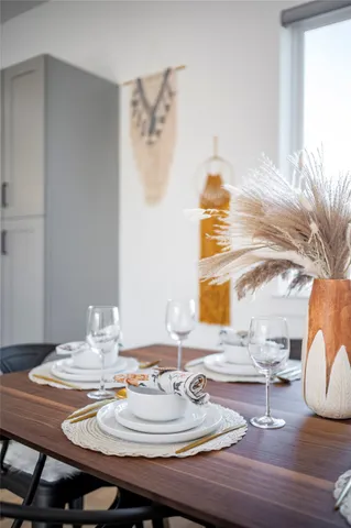 a dining room with furniture a kitchen view and a fireplace