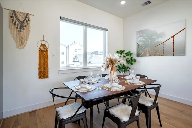 a view of a dining room with furniture and wooden floor