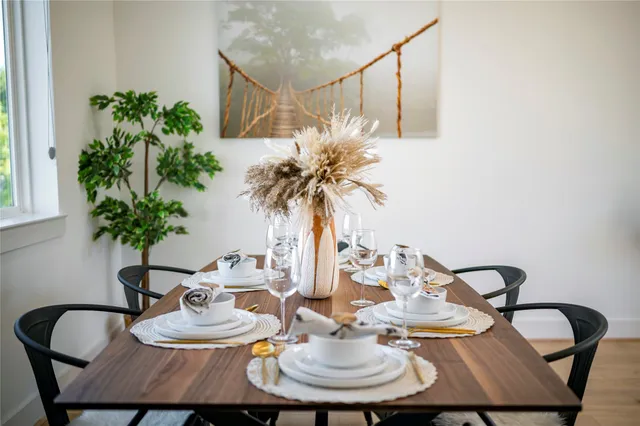 a living room with furniture kitchen view and a large window