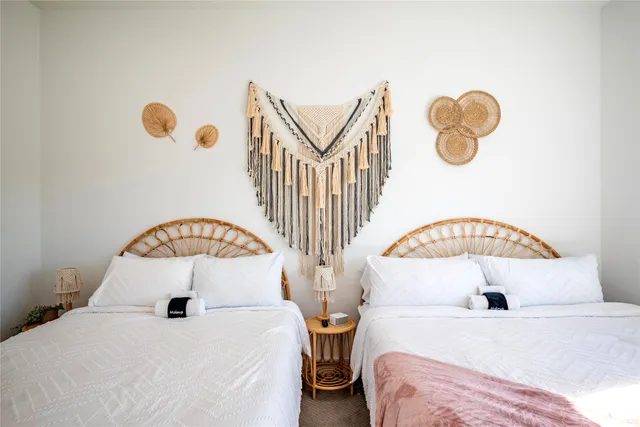 a bedroom with two beds and a window