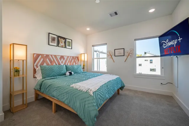 a spacious bedroom with a bed and a window