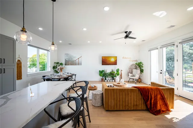 a living room with furniture and a chandelier