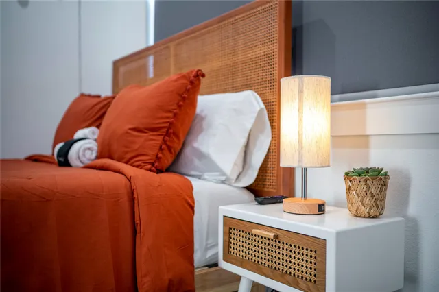 a bedroom with bed and a potted plant