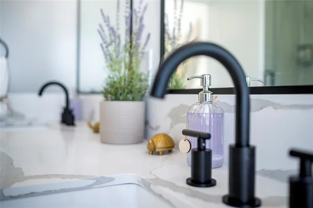 a bathroom with a double vanity sink and mirror