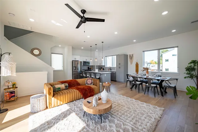 a living room with furniture kitchen view and a dining table