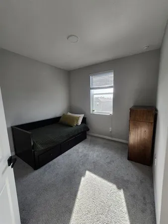 a living room with a couch and a window
