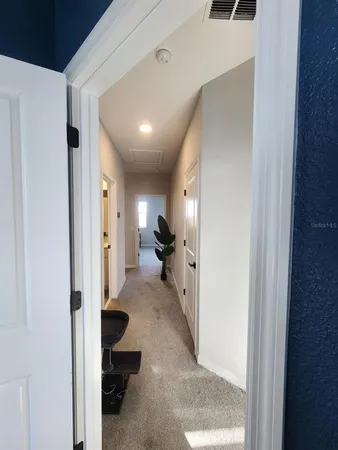 a view of a hallway with living room