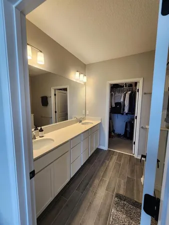 a bathroom with a double vanity sink and mirror