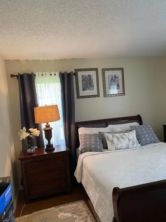 a bedroom with a bed and window