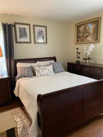 a bedroom with a bed and window