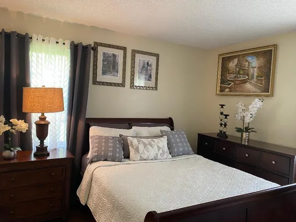 a bedroom with a bed and dresser