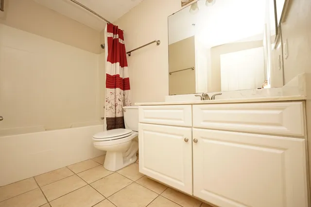 a bathroom with a bathtub sink vanity and toilet