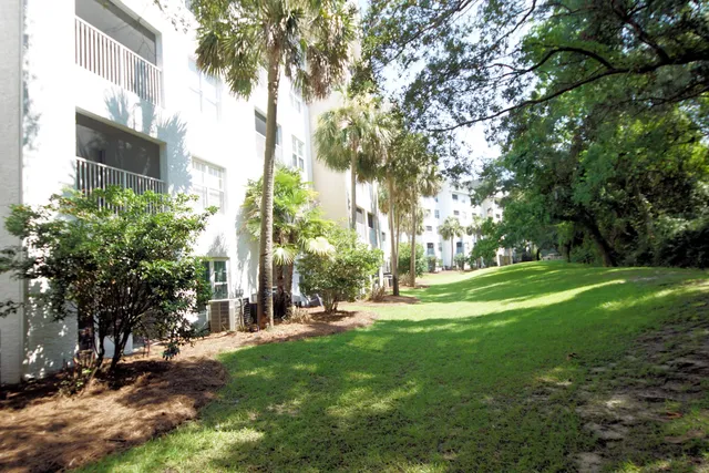 a backyard of a house with table and chairs