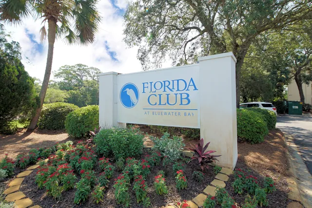 a sign broad in front of flowers