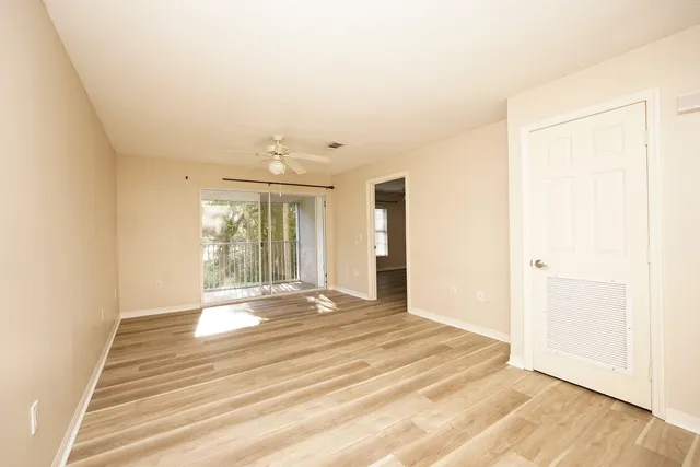 a view of an empty room with wooden floor