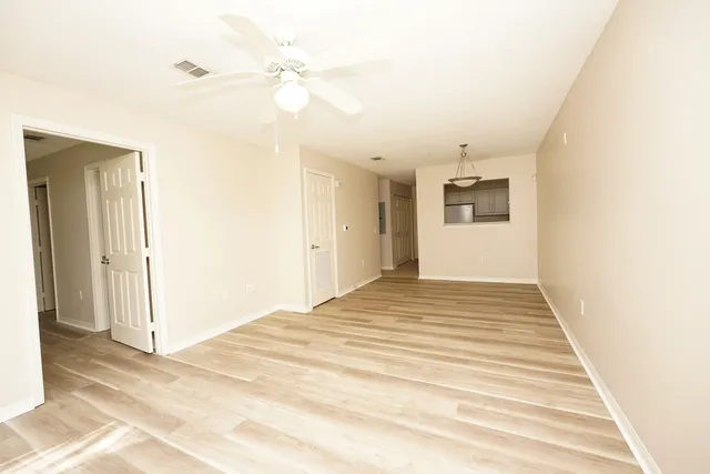 a view of a bedroom with a bed and ceiling fan