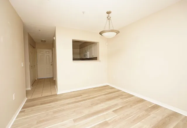 a view of a livingroom with wooden floor and a flat screen tv