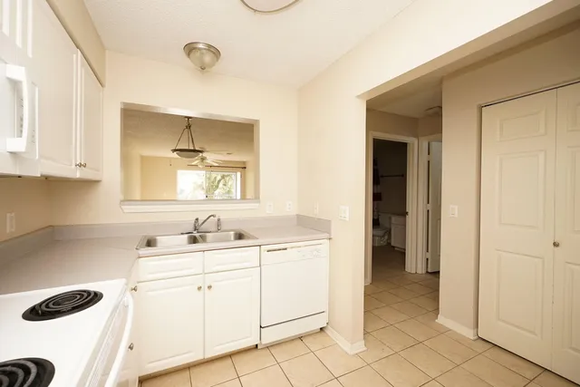 a kitchen with a sink cabinets and appliances