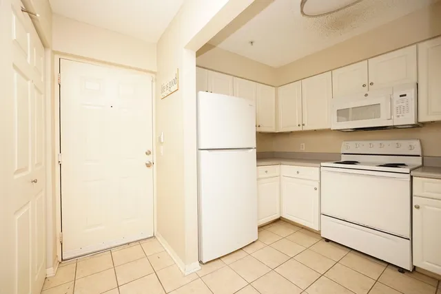a white refrigerator freezer and a dishwasher in it