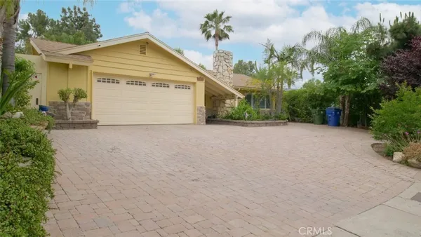a view of a house with a yard and garage