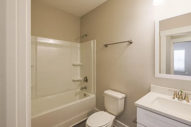 a bathroom with a toilet and a bathtub