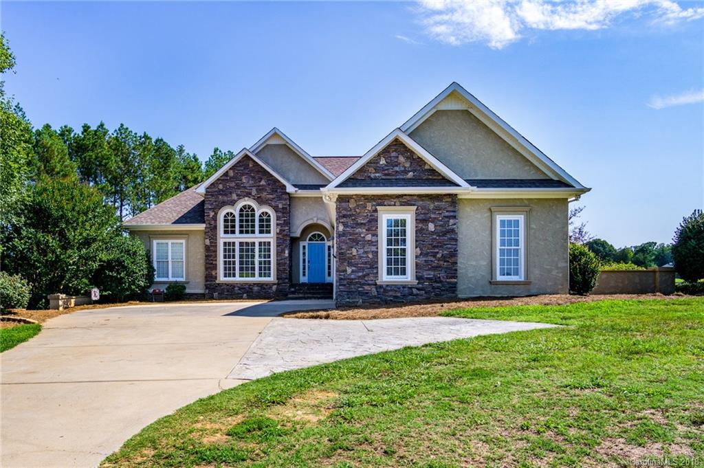 3526 Sincerity Road, Unit 13 Monroe, NC 28110 - Photo 1 of 20 a front view of a house with a yard and garage