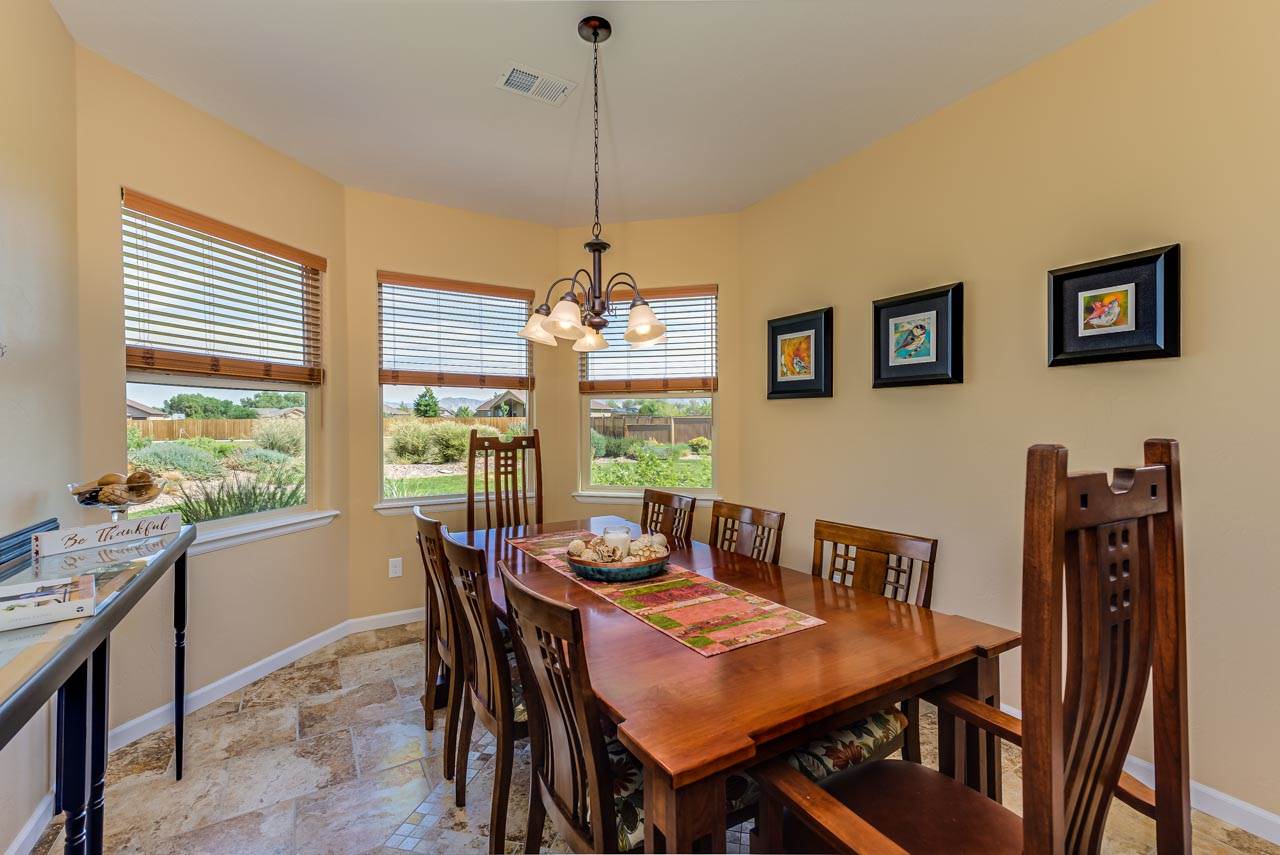 2530 Riata Ranch Court Grand Junction, CO 81505 - Photo 15 of 41 a view of a dining room with furniture window and outside view