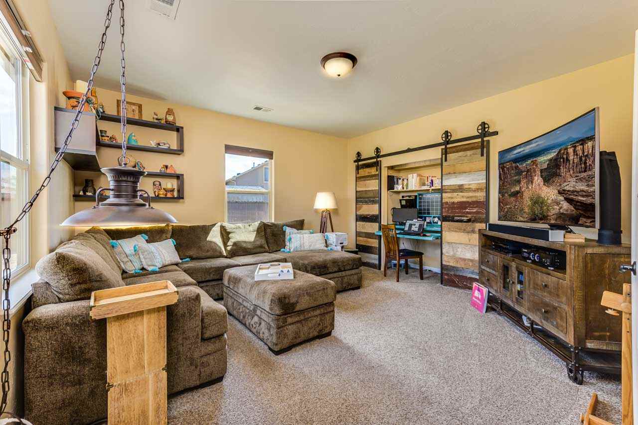 2530 Riata Ranch Court Grand Junction, CO 81505 - Photo 17 of 41 a living room with furniture and a flat screen tv