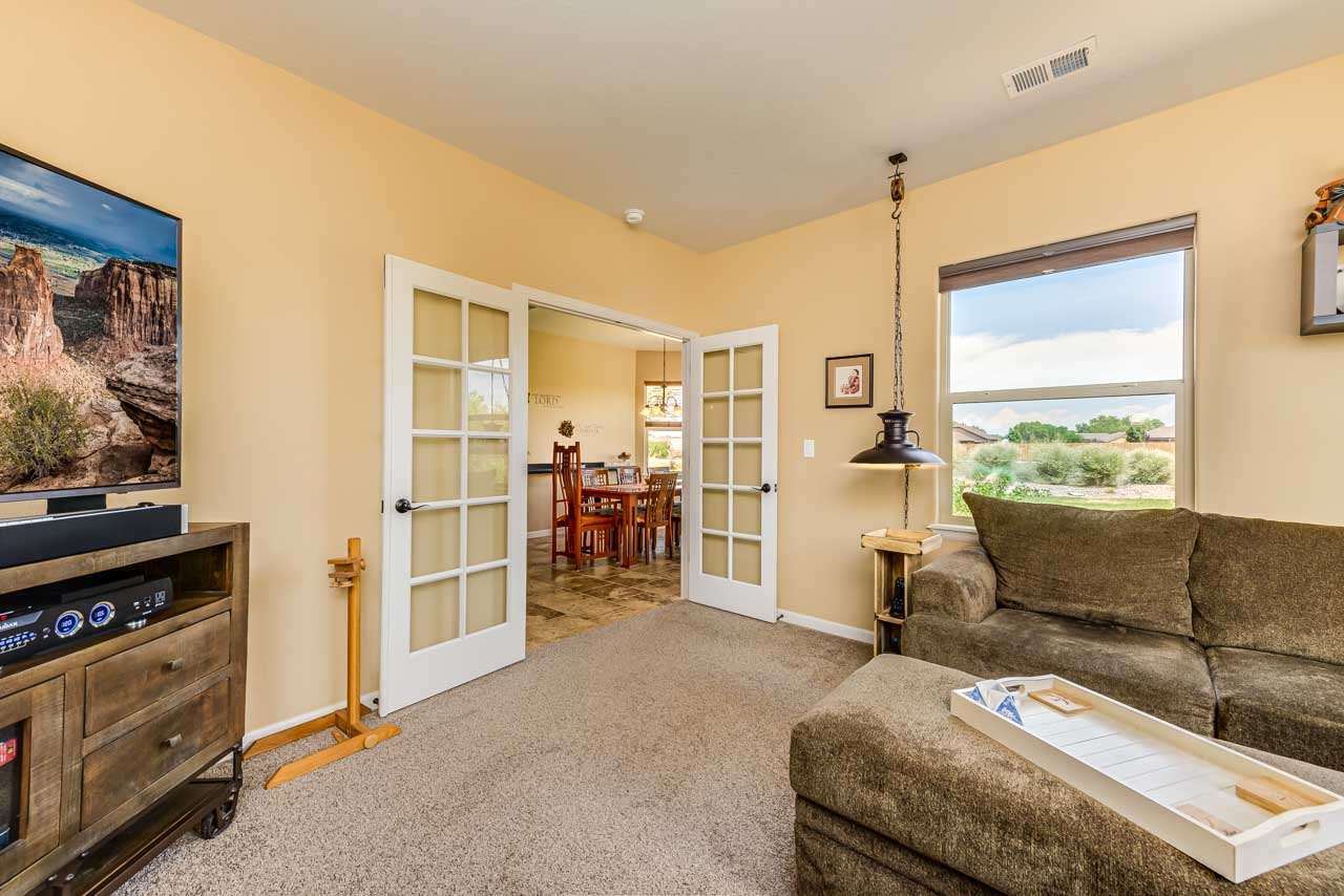 2530 Riata Ranch Court Grand Junction, CO 81505 - Photo 18 of 41 a living room with furniture and a flat screen tv